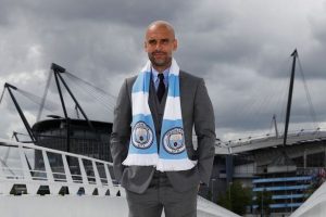 Pep-Guardiola-poses-outside-the-stadium-after-his-first-press-conference